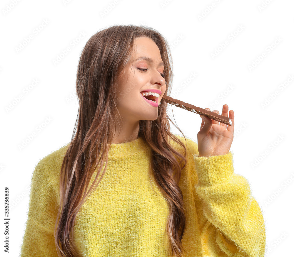 Beautiful young woman with chocolate on white background