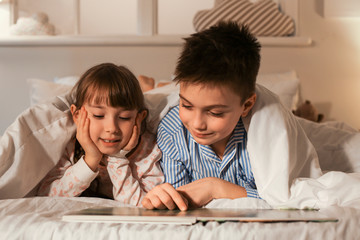 Wall Mural - Little children reading bedtime story at home