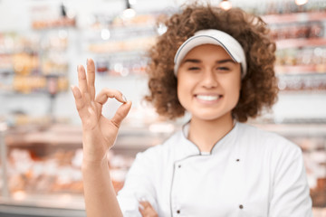 Wall Mural - Shop worker showing ok gesture.