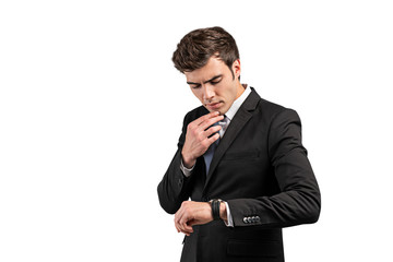 Wall Mural - Thoughtful businessman looking at watch, isolated