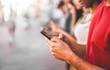 © DisobeyArt - Young people searching online news and information - Millennial guys using mobile phones outdoor - Technology addiction to smartphones devices concept - Focus on first hand