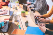 © DisobeyArt - Young co-workers team planning a new startup - Digital nomad people working on a new project in creative coworking office - Technology, smart work, marketing concept - Focus on right man close-up hand