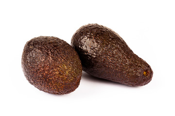 A simple pair of fresh ripe avocado. Two whole full round unpeeled fruit objects isolated on white background, cut out. Healthy natural exotic food, fruits, nutrition conceptual