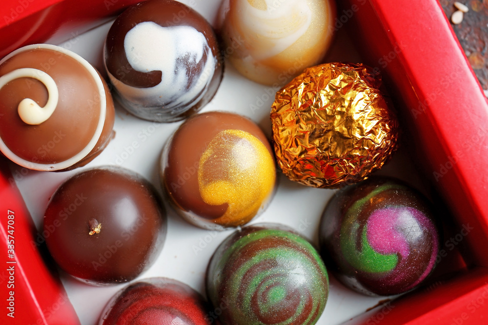 Box with delicious chocolate candies, closeup