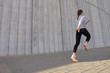 © ty - Young attractive woman with perfect slim body running outdoors. Fitness and running concept