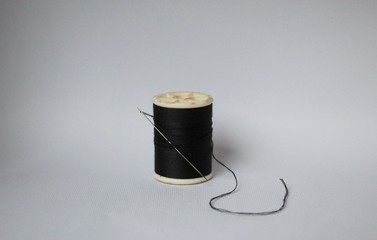 the black tread spool on white background