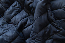 Black Puffer Jacket Material As Background Closeup