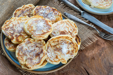 Fluffy homemade pancakes with apple dusted with icing sugar