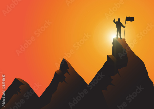 Fotografía Silhouette of man standing on top of the mountain with flag with fist raised up
