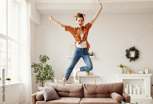 Fotografía Excited millennial woman listening to music and having fum at home