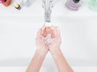 © Ed - A woman washes her hands under a water tap. Hygiene concept, top view, healthcare. Personal hygiene and body care