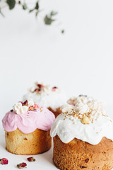 Wall Mural - Glazed easter cake decorated with flowers on white textured background. Happy Easter Holidays