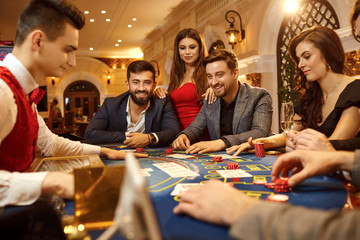 Sticker - A group of people playing poker roulette in a casino