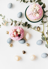 Wall Mural - Glazed easter cake kulich decorated with flowers and colored eggs on white textured background. Happy Easter Holidays.