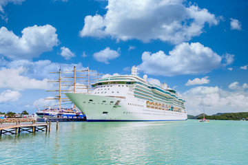 Wall Mural - White Cruise Ship by Wood Masts with tourists