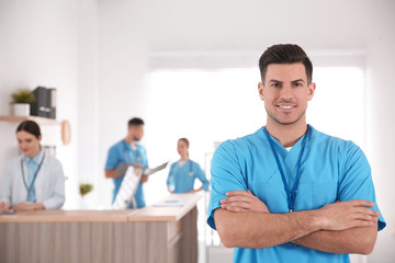 Wall Mural - Portrait of male doctor in modern clinic