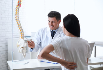 Wall Mural - Young woman visiting orthopedist in medical office