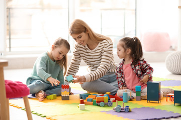 Wall Mural - Mother playing with her children at home