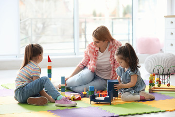 Poster - Mother playing with her children at home