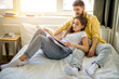 © alfa27 - married caucasian couple relax and enjoy together at home, couple lie on bed have a rest, read books. weekends, holidays, leisure time concept