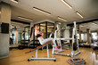 © BGStock72 - Young woman have a training at sit up bench in the gym