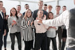 © ASDF - project Manager and a group of young professionals standing in the spacious lobby