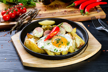 Poster - fried eggs and fried potatoes in a pan homemade food