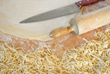 Fototapeta Tulipany - Pasta home makingcloseup in kitchen interior. The cooking process, raw pasta with flour