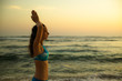 © Olga - Close up of namaste mudra. Young woman raising arms with namaste mudra at the beach. Anti stress. Melast beach, Bali, Indonesia