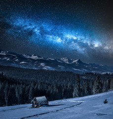 Wall Mural - milky way over wooden cottage in tatra mountain in winter