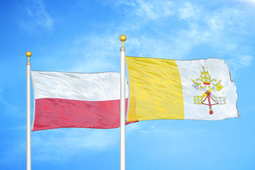 Poland and Vatican two flags on flagpoles and blue cloudy sky