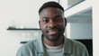 © Sofiia - Close up view of attractive african-american man looking into the camera and smiling in modern apartment at home smiling optimistic decisive healthy handsom portrait