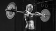 © USM Photography - Barbell Workout Indoor shot of caucasian female doing exercise with barbell Blonde woman crossfit workout in gym. Female performing deadlift exercise with weight bar Concept black and white photo.