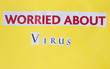 © magorzata - worried about virus inscription cut out on a yellow background, red letters