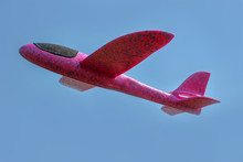 A Foam Throwing Glider Plane Flies In The Blue Sky