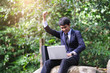 © Have a nice day  - male asian businessman using laptop computer technology working in nature surroundings, concept using internet connection emailing contacting people using wireless transfer communication technology