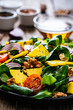 © Jacek Chabraszewski - Fresh salad - blue cheese, cherry tomatoes, vegetables and walnuts on wooden background