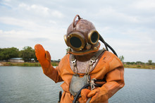 Diver Immerses In A Vintage Deep Sea Diving Suit