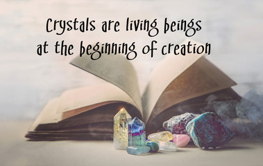 crystals are living beings at the beginning of creation - inspiration quote. crystals and old book. 