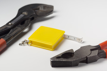 pliers wrench and tape measure on white background isolated