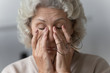 © fizkes - Head shot close up tired middle aged mature woman rubbing nose bridge after taking off eyewear. Frustrated stressed senior older grandmother suffering from blurred eyesight, eyes strain pain ache.