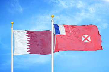 Qatar and Wallis and Futuna two flags on flagpoles and blue cloudy sky