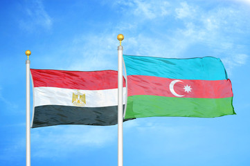 Egypt and Azerbaijan  two flags on flagpoles and blue cloudy sky