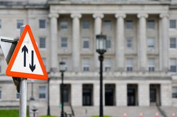 Two way traffic road sign outside Parliament Buildings, Stormont Estate symbolising negotiation and compromise between political parties.