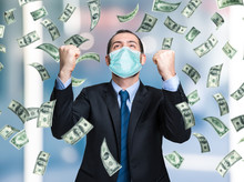 Businessman Enjoying A Rain Of Money While Wearing A Mask, Coronavirus Business Opportunities Concept