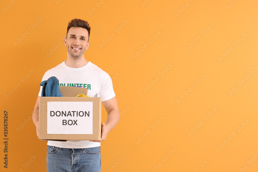 Volunteer with donations for orphans on color background