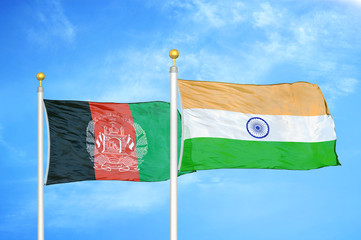 afghanistan and india two flags on flagpoles and blue cloudy sky