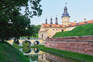 Wall Mural - Exterior of a medieval castle. View of an old castle with a fortress wall and a moat with water.