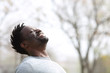 © PheelingsMedia - Happy black man breathing fresh air outdoors in winter