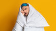 © Prostock-studio - Man in blanket at studio. Hiding from the light